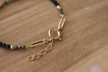 bracelet doré avec un joli mousqueton doré pour fermoir, orné de chaque coté de pyrite