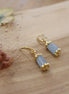 boucles d'oreilles tubes dorées avec pierre naturelle béryl